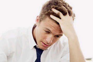 Person holding head, looking stressed