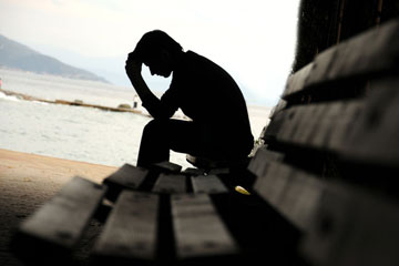Worried woman with hands near face